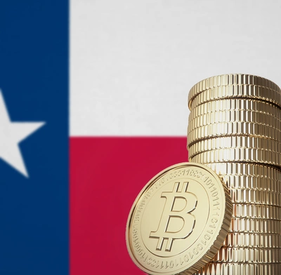 Texas flag and pile of bitcoin