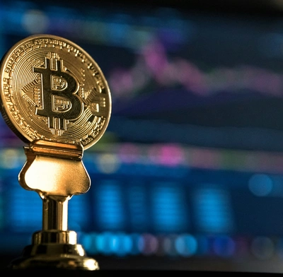  A Bitcoin with a price tracker in the background