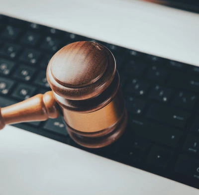 Judge's hammer hits a keyboard